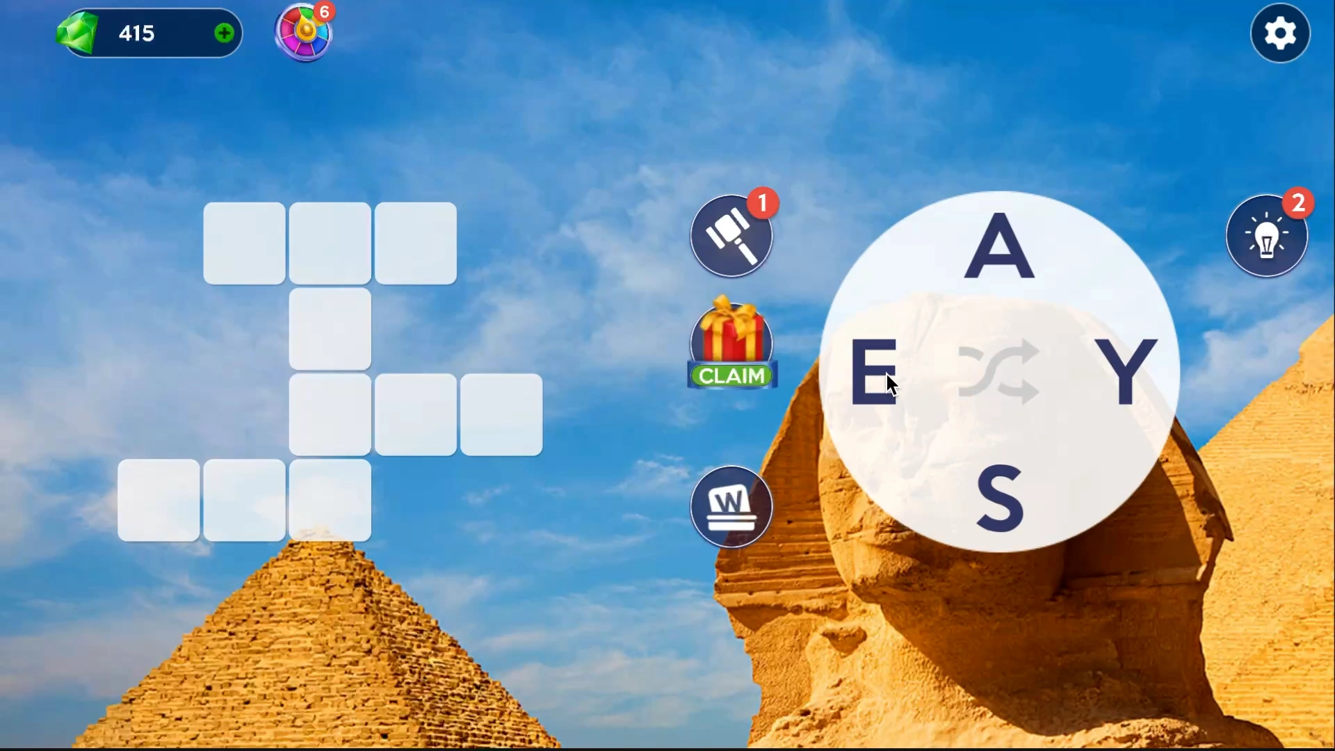 Words of Wonders puzzle gameplay in front of the Pyramids of Giza